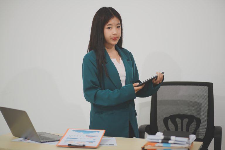 Business, finance and employment, female successful entrepreneurs concept. Friendly smiling office manager greeting new coworker. Businesswoman welcome clients with hand wave, hold laptop